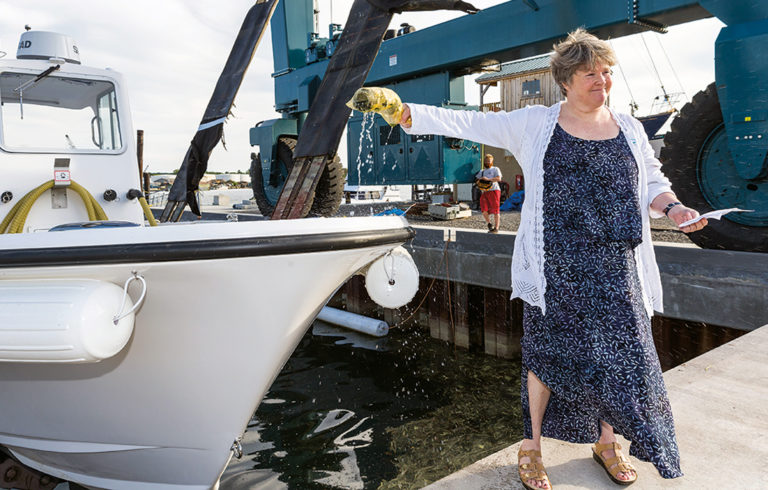 Capt. Pam Parker of the Maine Department of Environmental Protection christens Friends of Casco Bay’s new pump-out boat.