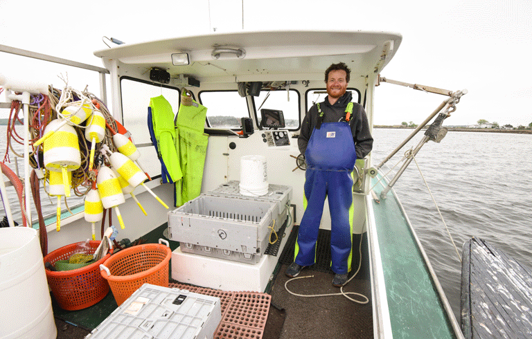 Ethan DeBery, owner of Fish 'n Trips, in Phippsburg aboard his AJ-28-foot lobster boat.