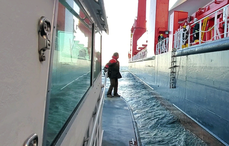 Capt. David Gelinas prepares to jump from the pilot boat onto a moving ship.