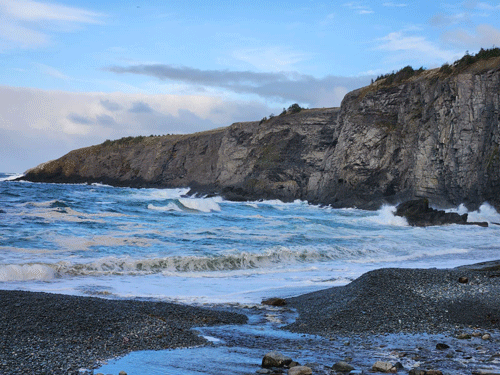 Rough seas, rough-edged cliffs mark the coast.