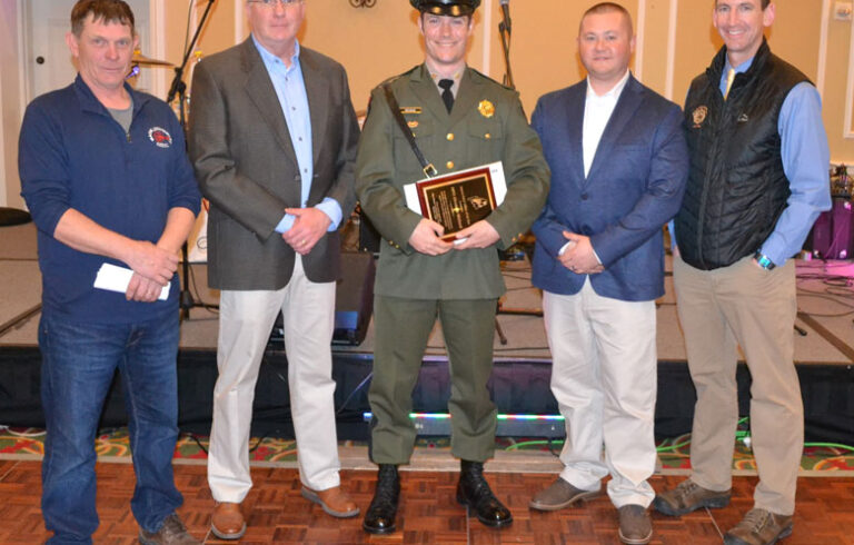 Maine Marine Patrol Officer Alex Michaud, center, receives the 2024 Maine Lobstermen’s Association Officer of the Year Award during the Fishermen’s Forum. From left are and MLA board president Kristan Porter Department of Marine Resources Commissioner Patrick Keliher, from left), Sgt. Matthew Wyman, and Major Rob Beal.