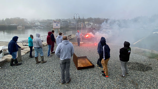 On a misty morning students receive flare training that could save lives in an emergency.