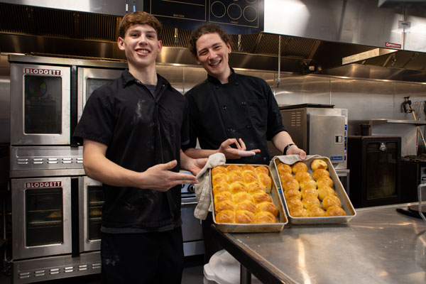 Grant Wilson and Alden Rousseau pose with their fresh-out-of-the-oven croissants.