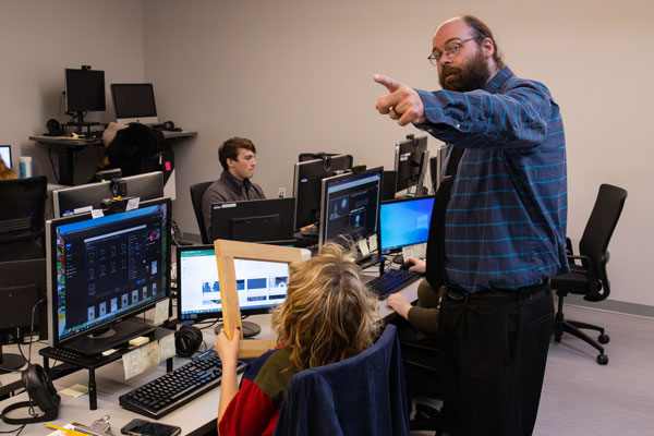 Brandon Soards directs a student in the design and technology program.