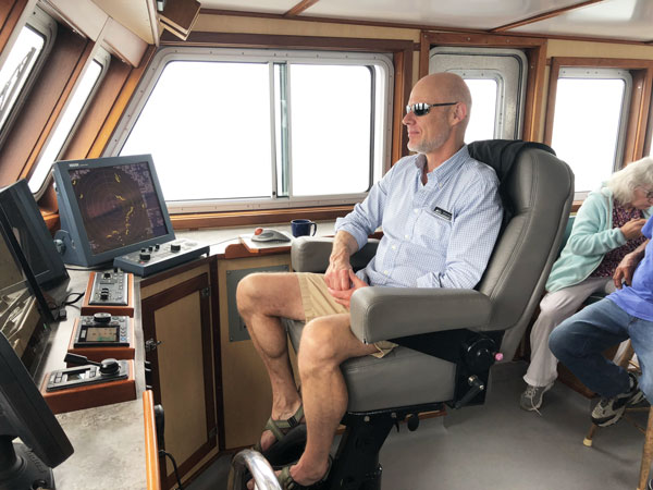 Capt. Mike Johnson peers through the fog, relying on the vessel’s electronic navigation aids. PHOTO: TOM GROENING