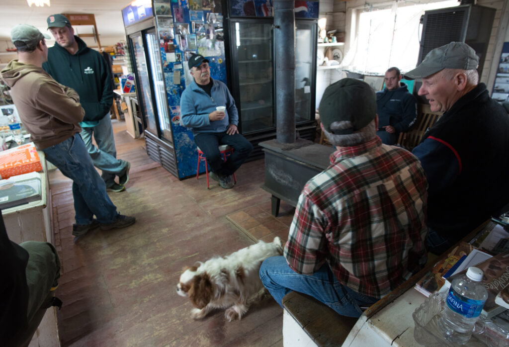 Harpswell fishermen sitting around woodstove at Watson's General Store