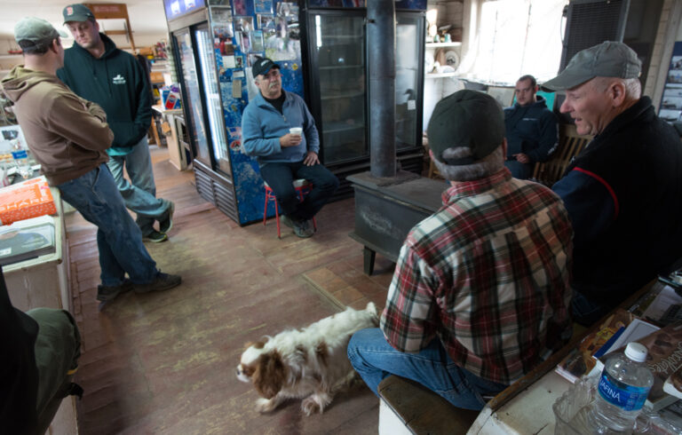 Harpswell fishermen sitting around woodstove at Watson's General Store