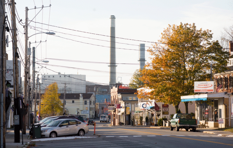 A view down Bucksport's Main Street, with the paper mill's smokestacks in view.