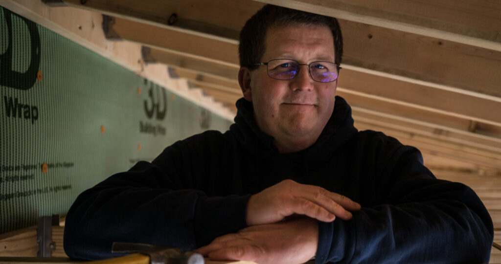 man standing in house frame