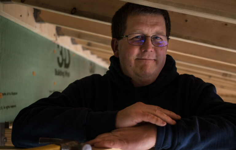 man standing in house frame