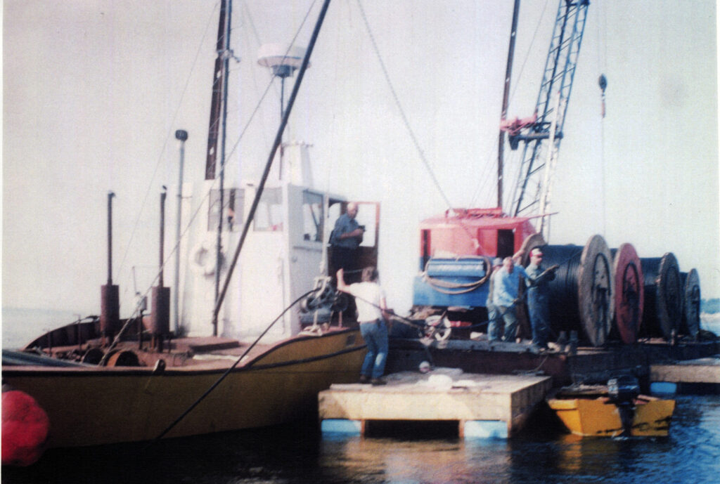 old color photo of dock with cable spools