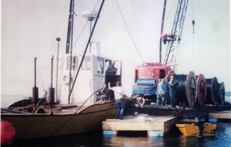 old color photo of dock with cable spools