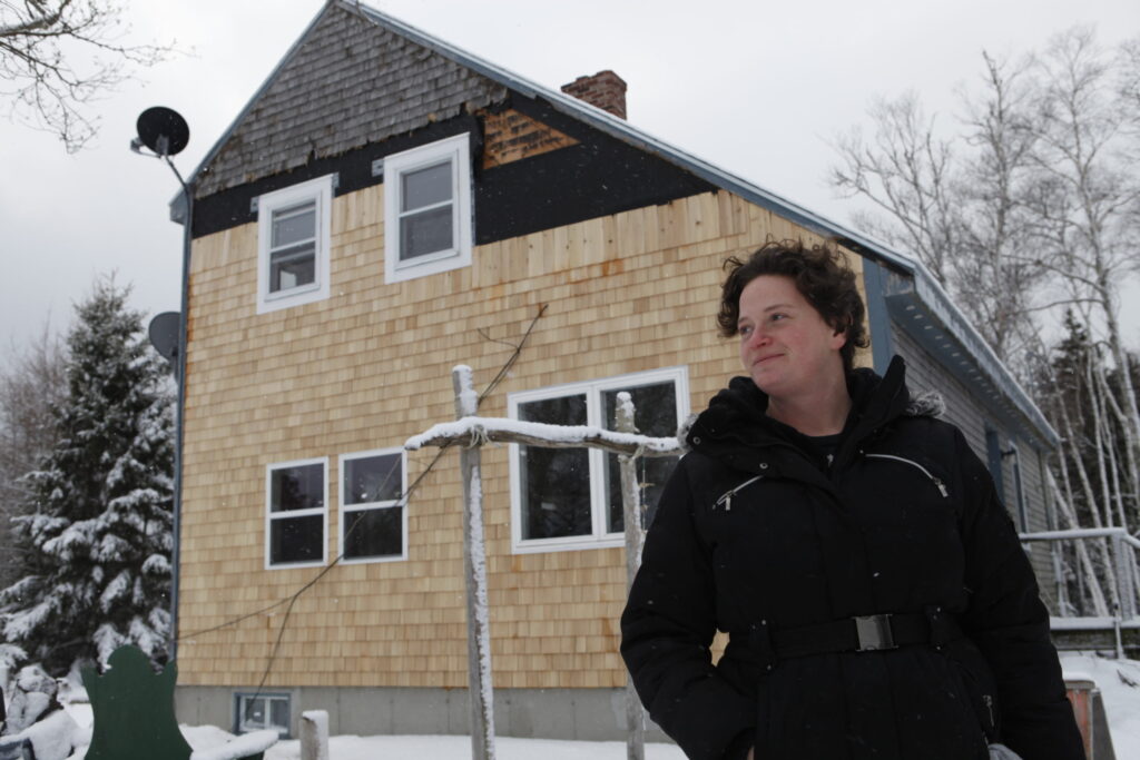 woman standing in front of house during winter