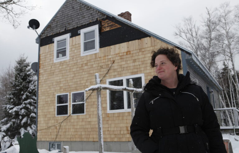 woman standing in front of house during winter