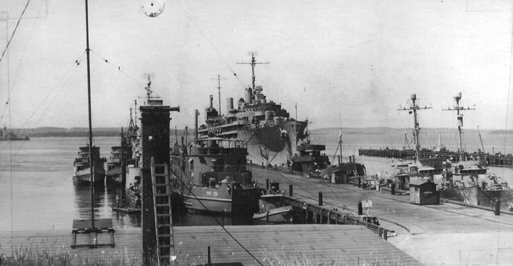 black and white photo of docked world war II vessels