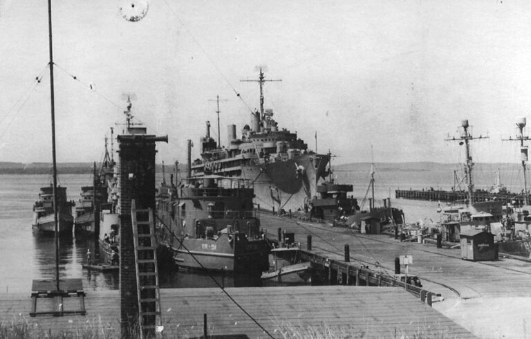 black and white photo of docked world war II vessels