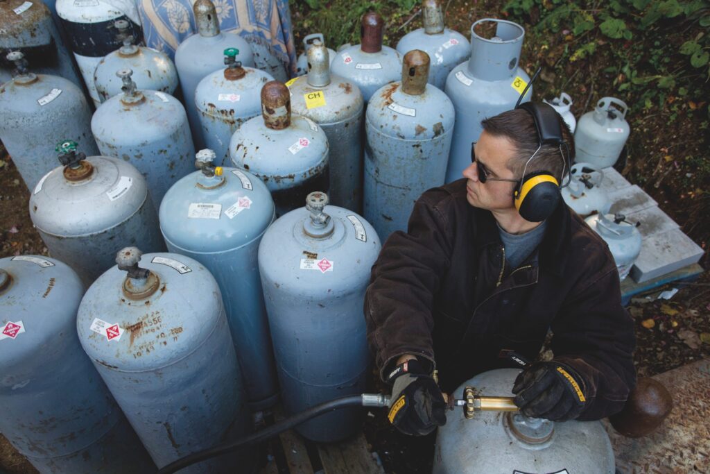 man with fuel tanks