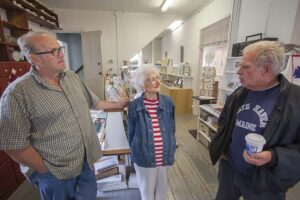 June's son David, at left, with his mother and a customer at the gift shop.