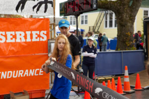 Allen and his daughter Matilda prepare for the finish of the women's half-marathon in Southwest Harbor.