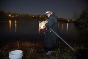 Veronica Sapiel stands on the banks of the St. Croix River in Calais, with St. Stephen, New Brunswick, on the other side.