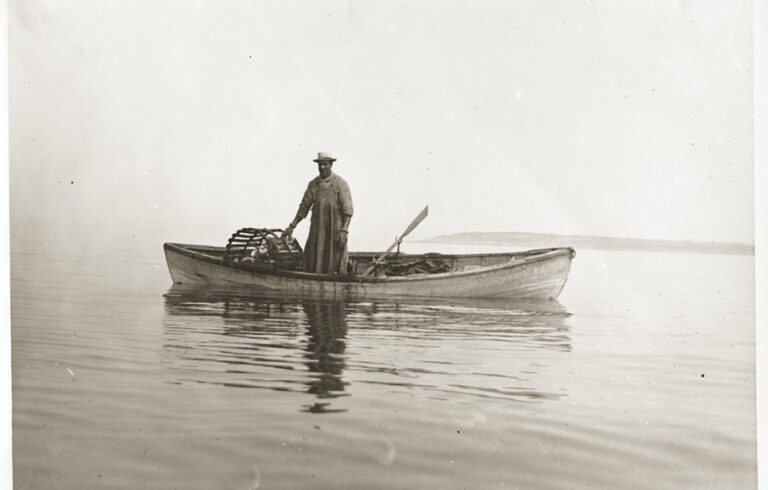 old photo of a man in a canoe