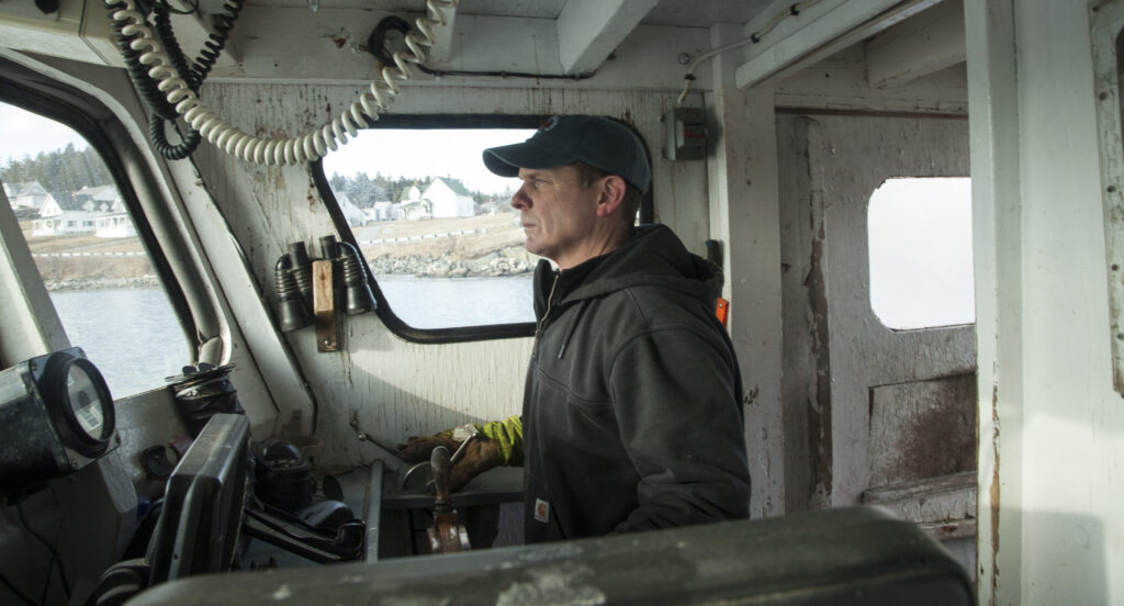 man at the wheel of a boat