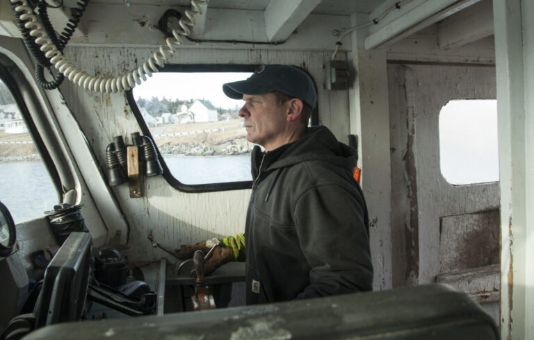 man at the wheel of a boat