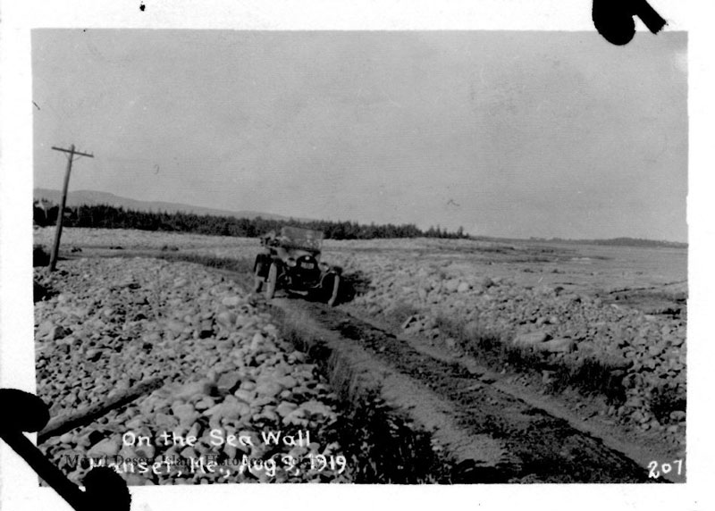 A 1919 photo from the Mount Desert Island Historical Society shows an automobile on the dirt road at Seawall, with rocks on either side. PHOTO: COURTESY MOUNT DESERT ISLAND HISTORICAL SOCIETY