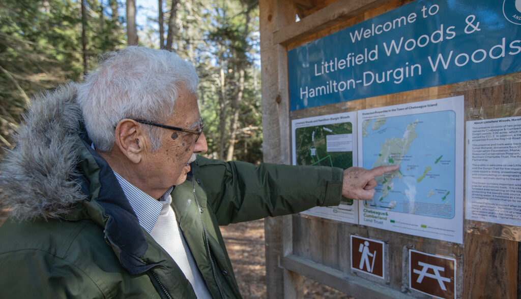 Man points at trail sign