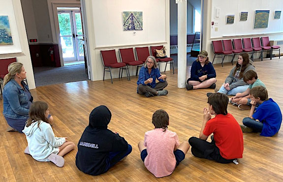 Whelan meets with a group of summer camp children at the Eastport Arts Center to talk about her show “Echoes of Place,” her life as an artist and reporter, and to show them how to make rubbings of found textures using scraps of canvas and crayons. PHOTO: LAUREN KOSS