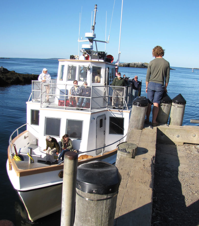 A boat arrives at the Monhegan pier. FILE PHOTO: TOM GROENING