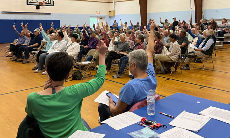 Residents of Penobscot vote to enact an ordinance regulating aquaculture operations at a meeting last year.